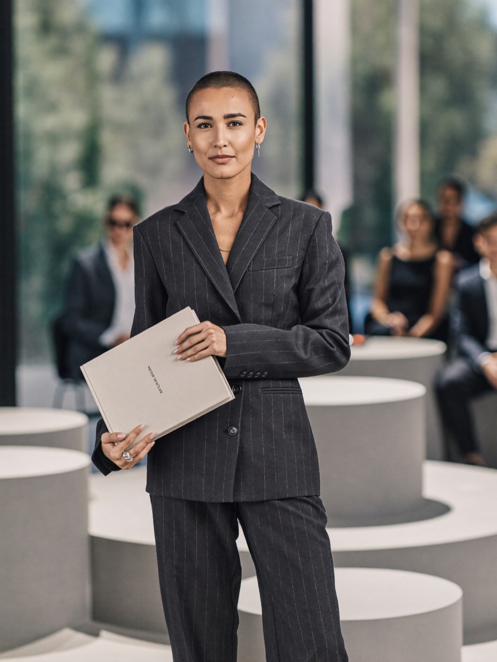 A woman presenting her book at a conference
